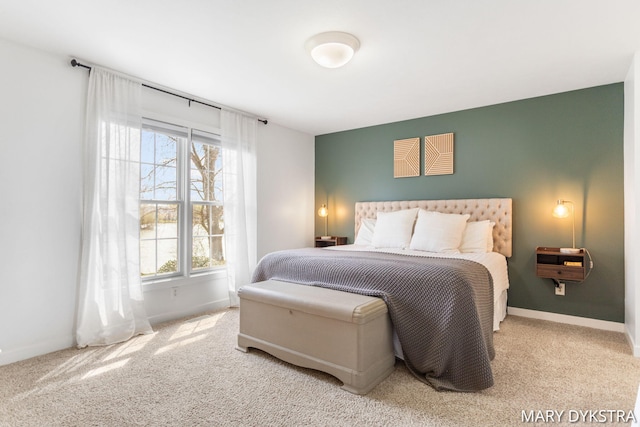 carpeted bedroom featuring baseboards and multiple windows