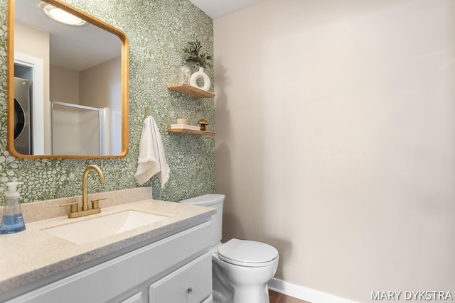 full bathroom with a shower with door, toilet, wallpapered walls, and vanity