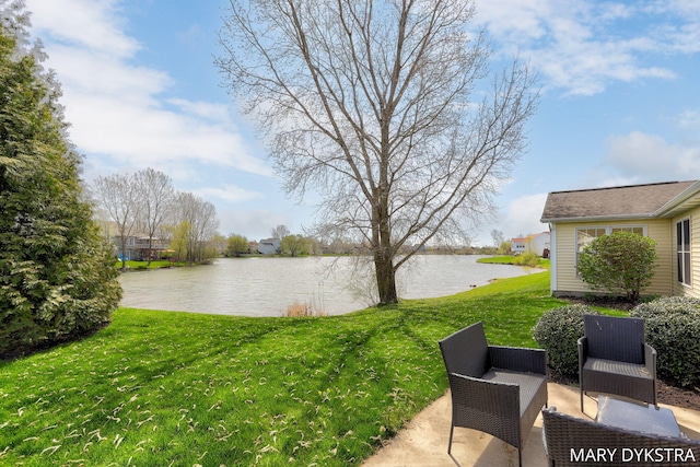 view of yard featuring a water view and a patio area