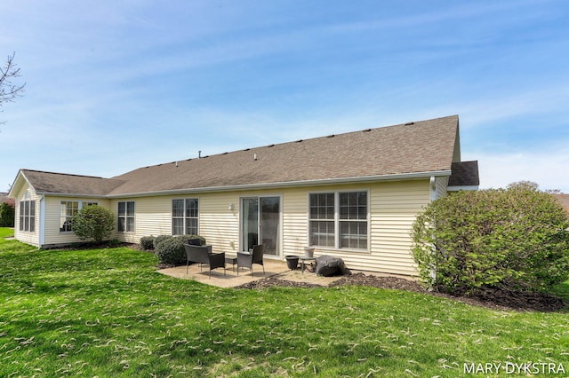 rear view of house featuring a lawn and a patio
