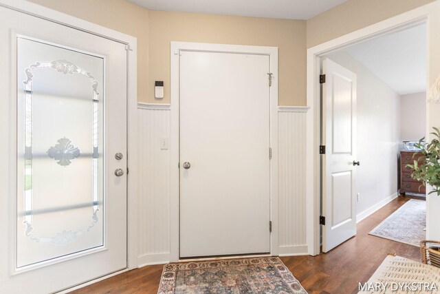 entryway featuring a wainscoted wall and wood finished floors