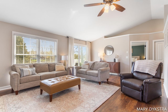 living room featuring a ceiling fan, vaulted ceiling, and dark wood-type flooring