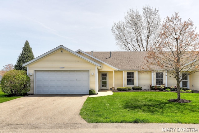 single story home featuring an attached garage, a front lawn, roof with shingles, and concrete driveway