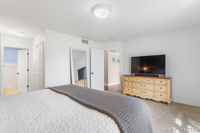 bedroom with baseboards, carpet, and visible vents