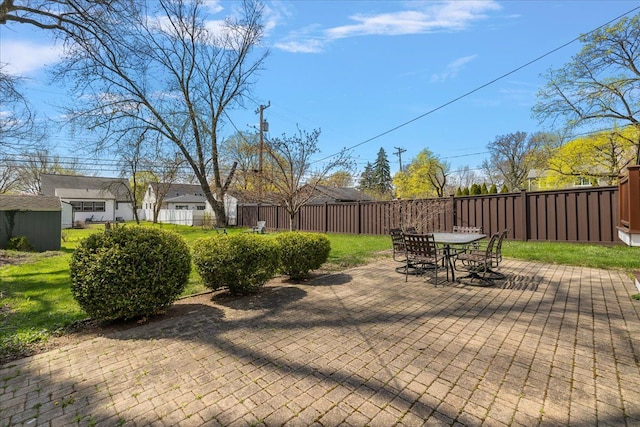 view of patio with outdoor dining space and fence private yard