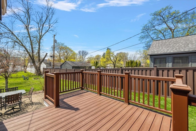 wooden terrace with outdoor dining space, a yard, and fence private yard