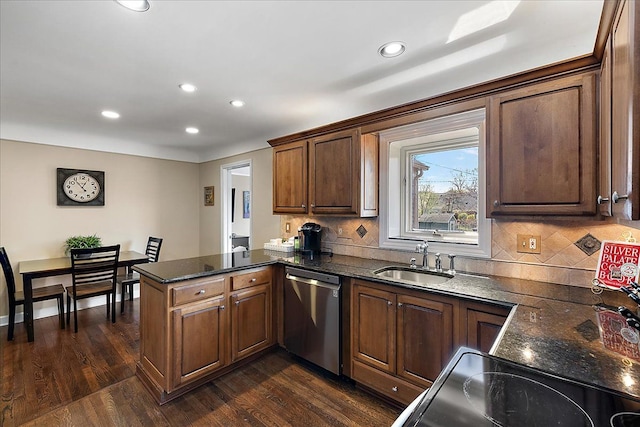 kitchen featuring a peninsula, recessed lighting, a sink, and dishwasher