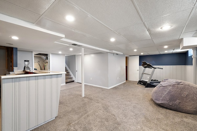 interior space with visible vents, light colored carpet, a dry bar, a wainscoted wall, and recessed lighting