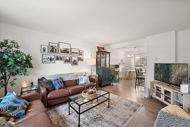 living room with wood finished floors and a chandelier