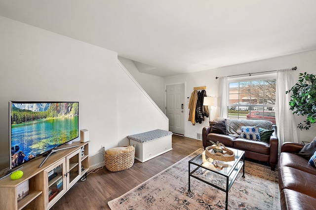 living area featuring baseboards, wood finished floors, and visible vents