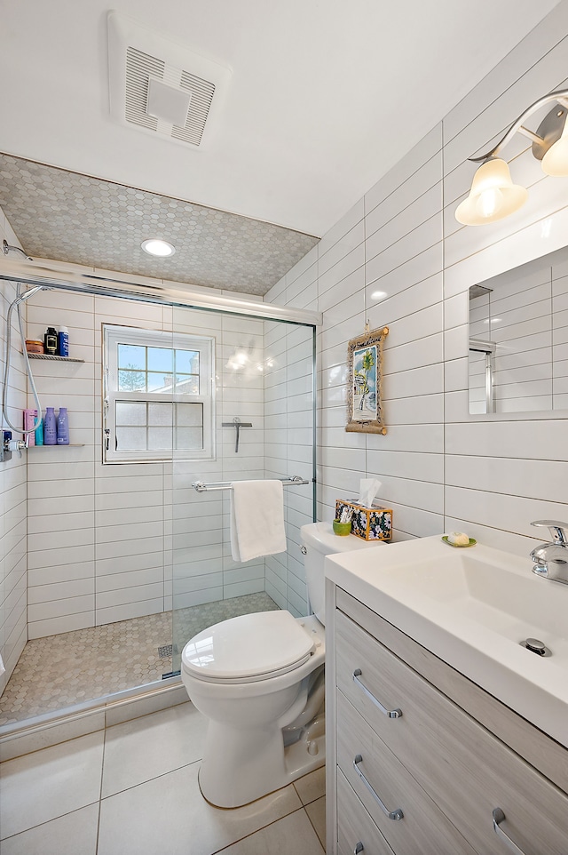 bathroom featuring toilet, visible vents, a shower stall, and vanity