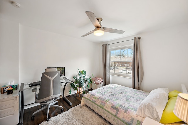 bedroom with ceiling fan and dark wood-type flooring