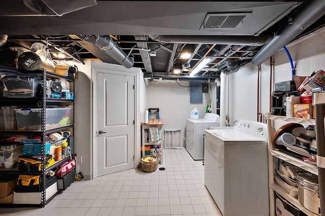 laundry room with light tile patterned flooring, laundry area, separate washer and dryer, visible vents, and electric panel