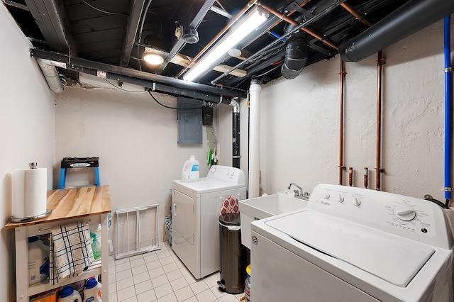 laundry area featuring independent washer and dryer, laundry area, light tile patterned floors, and electric panel
