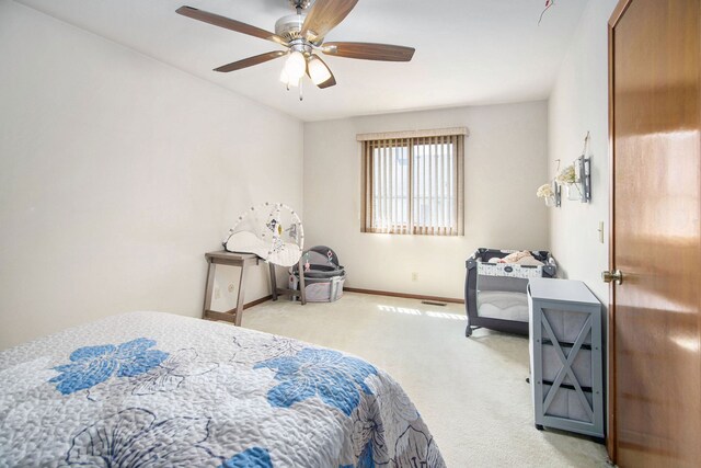 carpeted bedroom with a ceiling fan and baseboards