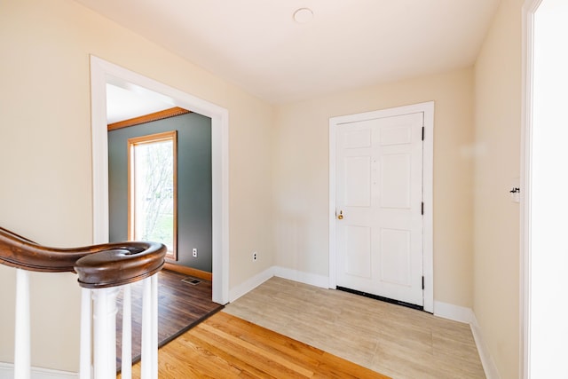 entrance foyer with baseboards and light wood-style flooring