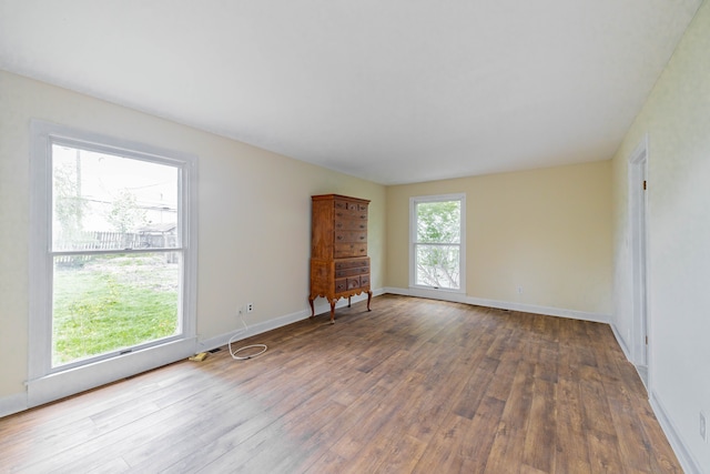 interior space with wood-type flooring and baseboards