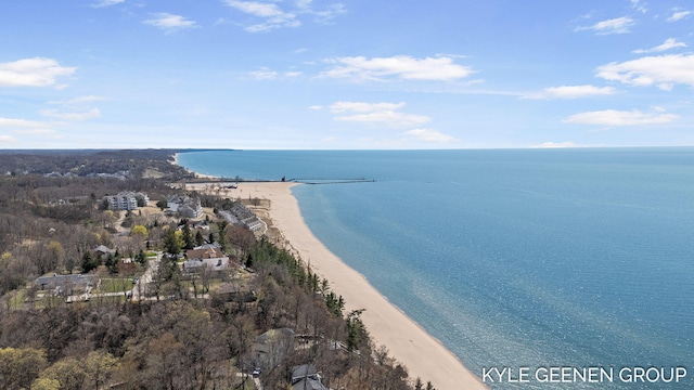 drone / aerial view featuring a water view and a view of the beach