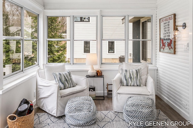 sunroom with wood walls and wood finished floors