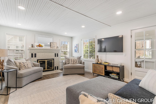 living area featuring recessed lighting, wood finished floors, wood ceiling, and a fireplace