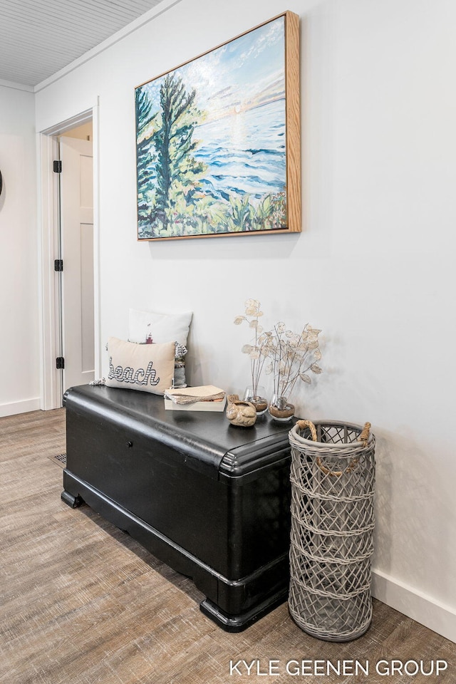 interior details with crown molding, baseboards, and wood finished floors