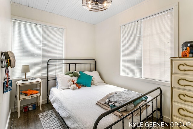 bedroom featuring baseboards and wood finished floors