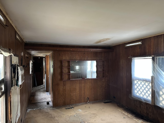 unfurnished room with wood walls