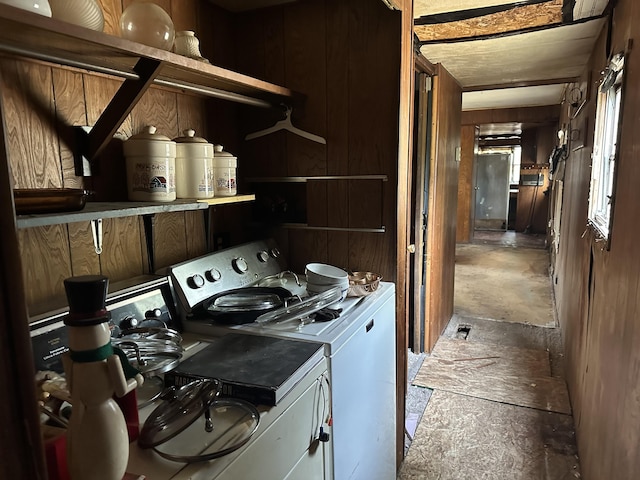laundry area with laundry area, wooden walls, and separate washer and dryer