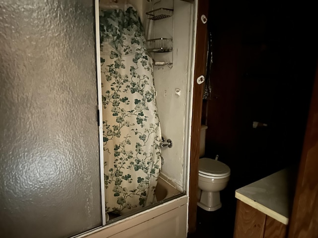 full bathroom with toilet and combined bath / shower with glass door