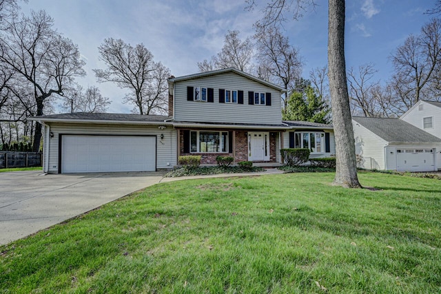 traditional-style house with fence, an attached garage, driveway, and a front yard