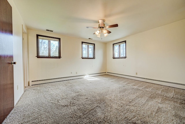 unfurnished room featuring baseboards, a ceiling fan, carpet flooring, and visible vents