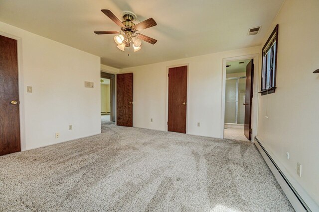 unfurnished bedroom with ceiling fan, carpet, a baseboard heating unit, and visible vents