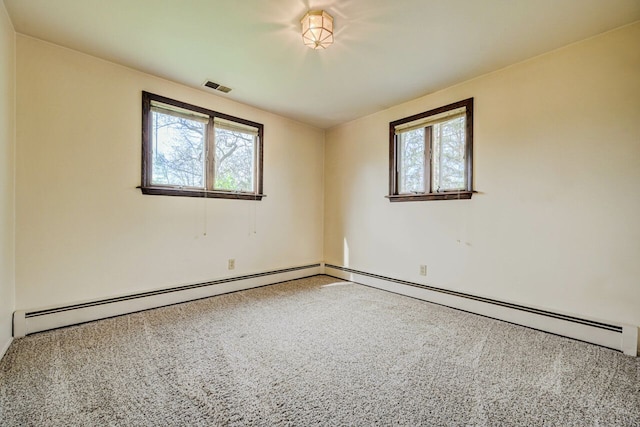 spare room featuring baseboards, visible vents, carpet, and a wealth of natural light