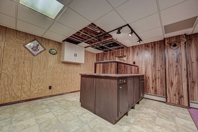 bar with wooden walls, track lighting, a dry bar, and a baseboard radiator