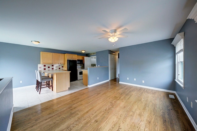 3067 Oakridge, Lake Orion, MI 48360 - unfurnished living room with a ceiling fan, light wood-type flooring, and baseboards