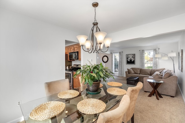dining room with a chandelier and light colored carpet