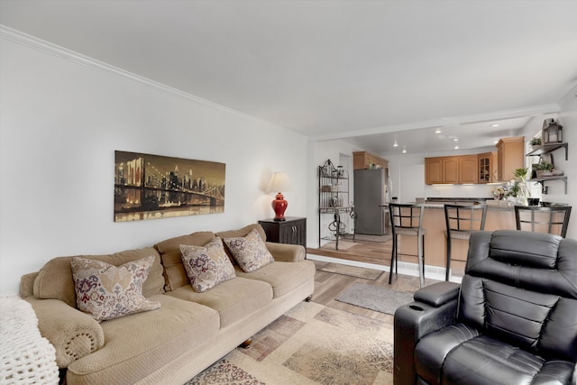 living area featuring crown molding, recessed lighting, and light wood-type flooring