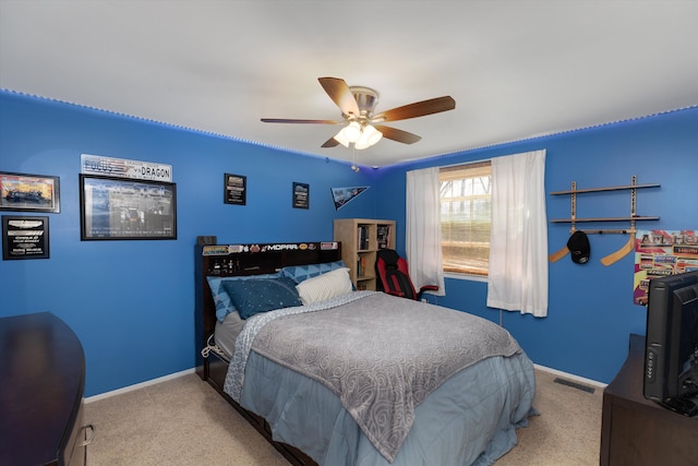 carpeted bedroom with baseboards, a ceiling fan, and visible vents