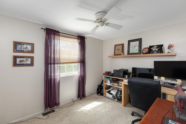 carpeted office space featuring ceiling fan, visible vents, and baseboards