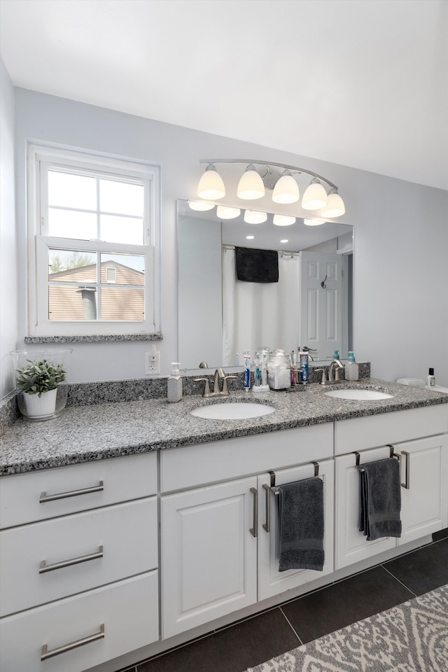 full bathroom with a sink, tile patterned floors, and double vanity