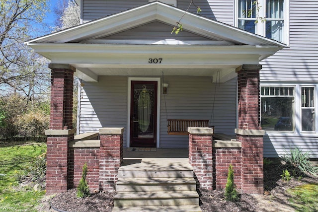 entrance to property featuring a porch