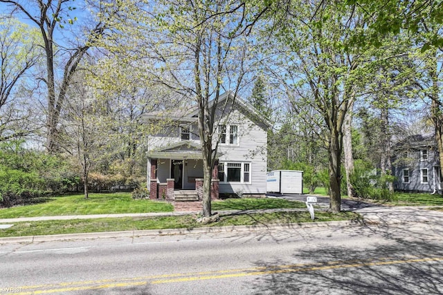 view of front of property with a porch and a front yard
