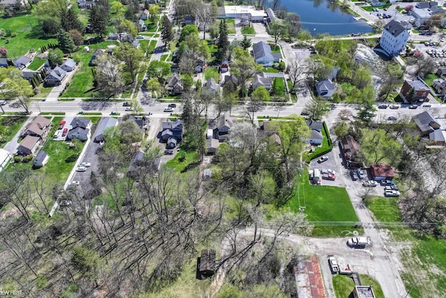 birds eye view of property with a water view and a residential view