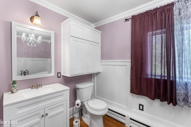 bathroom with vanity, ornamental molding, toilet, a chandelier, and a baseboard radiator