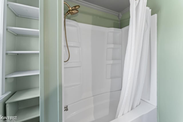 bathroom with crown molding and shower / bath combination with curtain