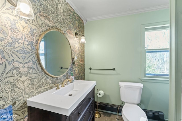 half bath with vanity, ornamental molding, toilet, baseboards, and wallpapered walls