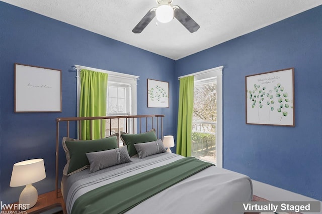bedroom with multiple windows and a ceiling fan