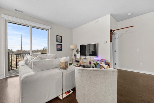 living area featuring baseboards, dark wood finished floors, and visible vents