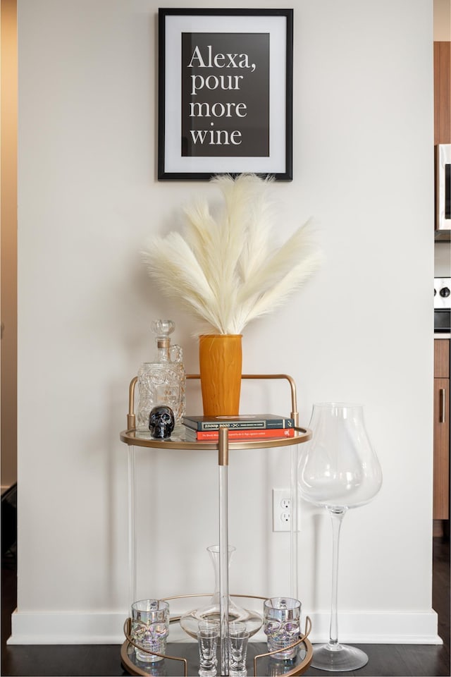 room details featuring baseboards and white microwave