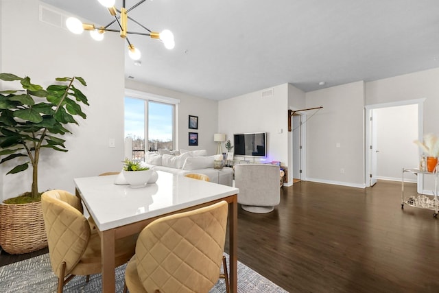 dining room with baseboards, a notable chandelier, visible vents, and dark wood-type flooring
